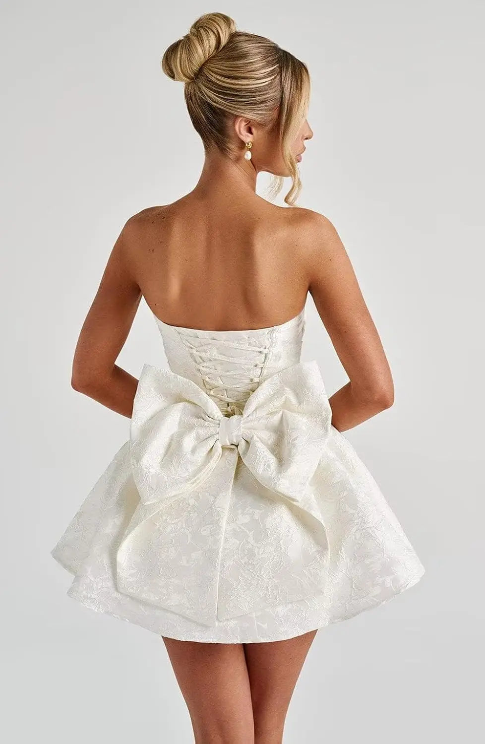 Make a dazzling entrance in this elegant strapless homecoming dress